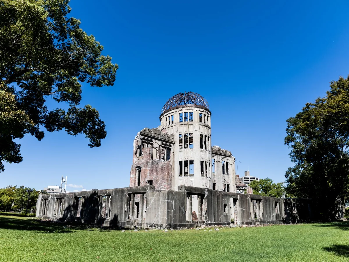 The ruined dome of the former Hiroshima Prefectural Industrial Promotion Hall, known as the A-Bomb Dome, under a blue sky